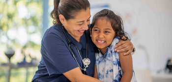 Nurse and child hugging